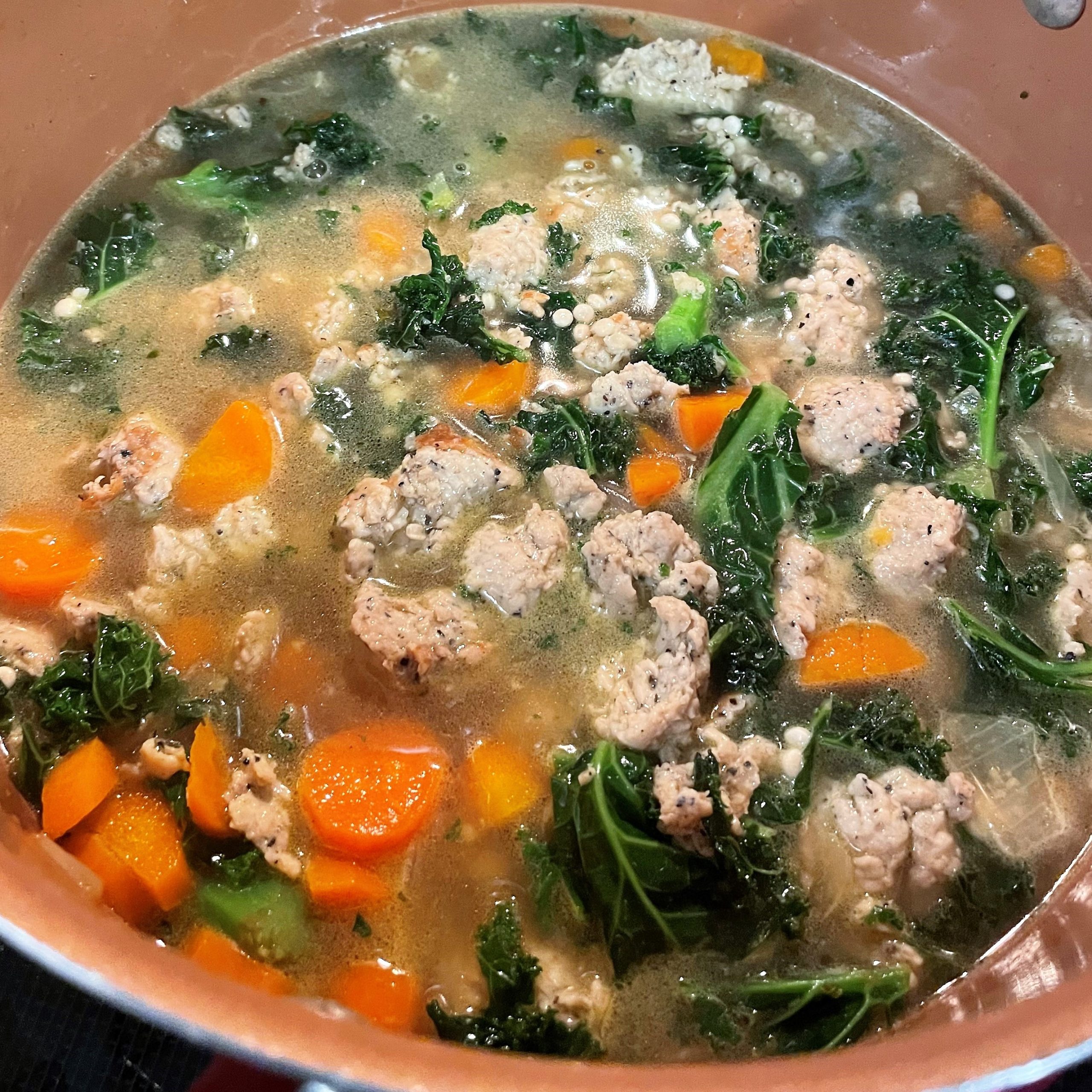 Chicken sausage and kale soup in pot