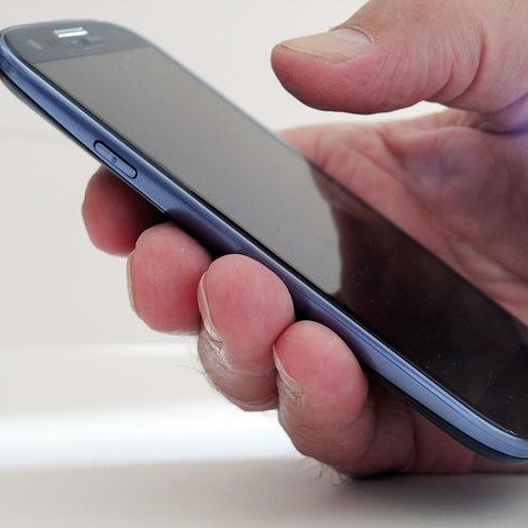 Hand holding cell phone